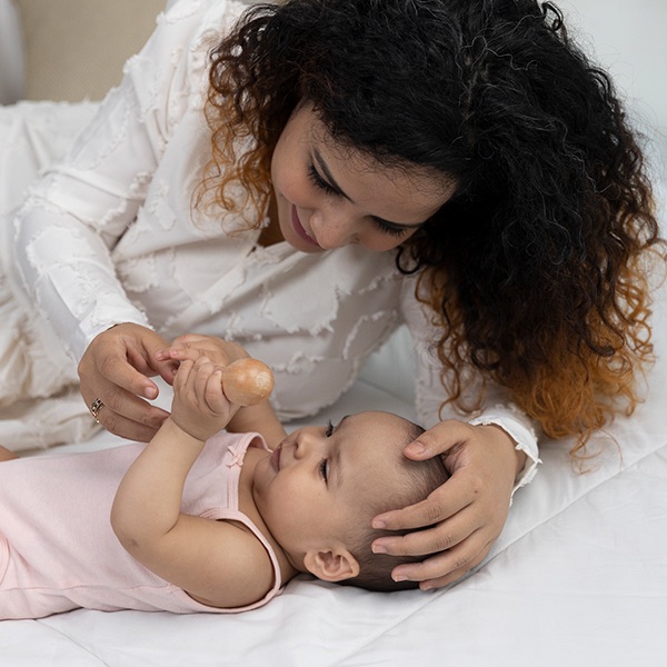 A parent holding their newborn close, faces near